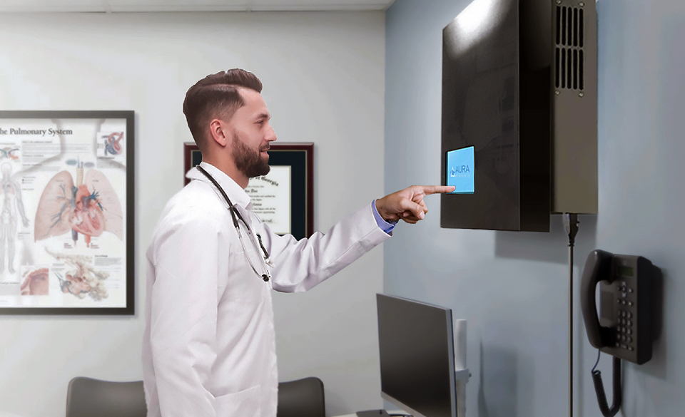 Doctor interacting with AURA unit mounted on exam room wall